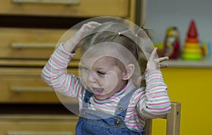 Little girl playing and studying on lessons in kindergarden