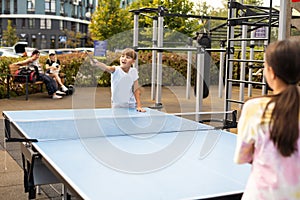 little girl playing table tennis in the tennis hall, tennis racket hitting the ball, the pitch of the ball.