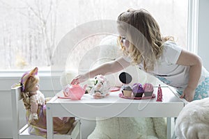 A little girl playing tea party