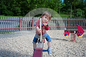 Little girl playing on a teeter