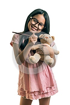 Little girl,playing together with a doll, on white background