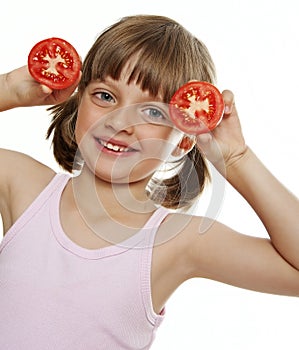 Little girl playing with a tomato