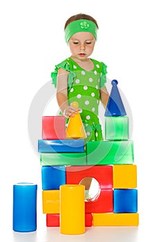 Little girl is playing with toy cubes