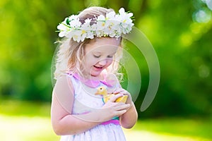 Little girl playing with a toy duck