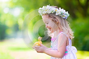 Little girl playing with a toy duck