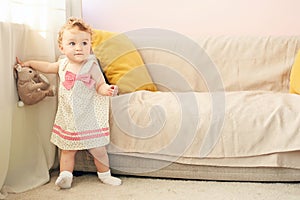 Little girl playing with toy rabbit