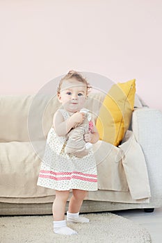 Little girl playing with toy rabbit