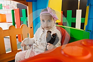 Little girl is playing with toys in the children`s room