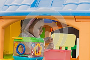 Little girl is playing with toys in the children`s room