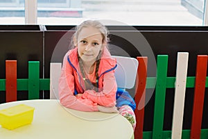 Little girl is playing with toys in the children`s room