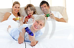 Little girl playing video game with her family