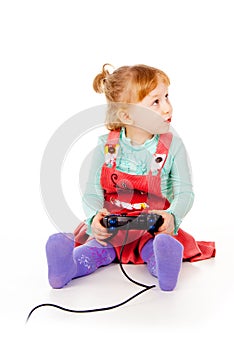 Little girl playing video games on the joystick