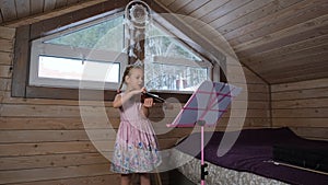 Little Girl Playing Violin in the Attic