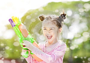 little girl playing water guns