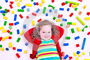 Little girl playing with wooden blocks