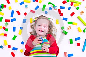 Little girl playing with wooden blocks