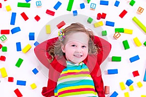 Little girl playing with wooden blocks