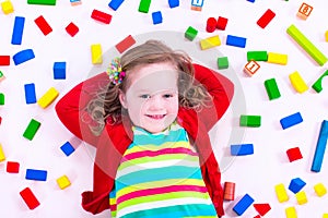 Little girl playing with wooden blocks