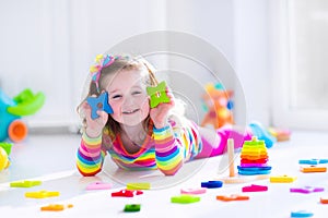 Little girl playing with wooden toys