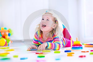 Little girl playing with wooden toys