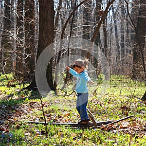 Little girl playing in woods