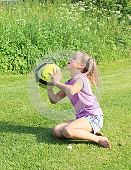 Little girl playing with yellow ball