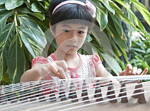 Little girl playing zither photo