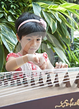 Little girl playing zither photo