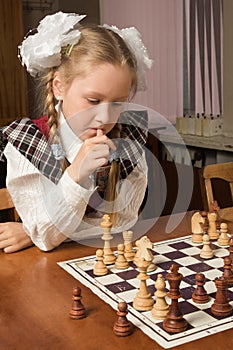 Little girl plays chess