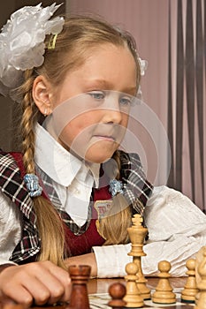 Little girl plays chess