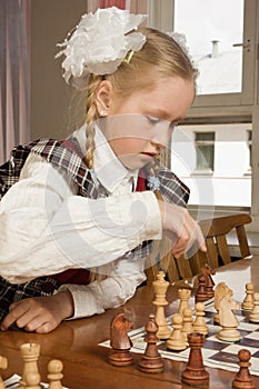 Little girl plays chess