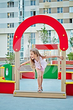 Little girl plays on children playground in house