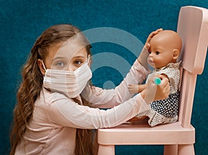 Little girl plays doctor, makes an injection to the doll