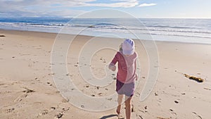 Little Girl Plays on Empty California Beach