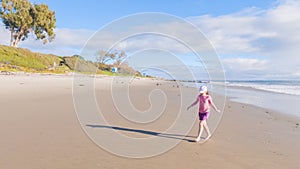 Little Girl Plays on Empty California Beach