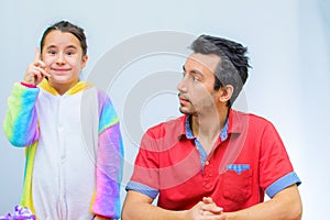 Little girl plays with her father at home in a beauty salon, combing her hair