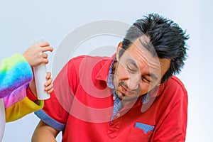 Little girl plays with her father at home in a beauty salon, combing her hair