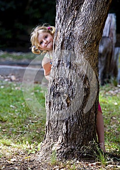 Little girl plays hide and seek
