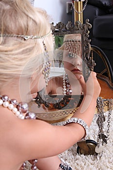 Little girl plays with jewelry