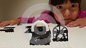Little girl plays with Lego constructor