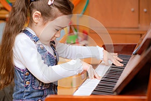 Little girl plays piano