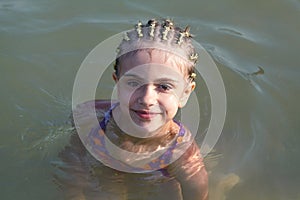 Little girl plays in the sea