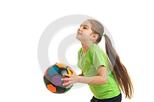 Little girl plays with a soccer ball