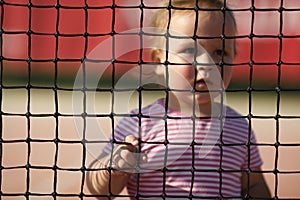 Little girl plays tennis