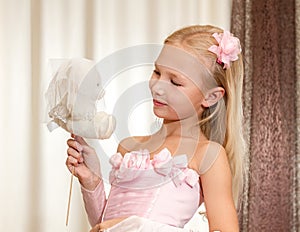 Little girl plays with wedding teddy-bear