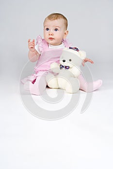 Little girl with plushy cuddle-bear. photo