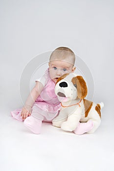 Little girl with plushy doggy.