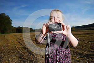 Little girl with pocket camera