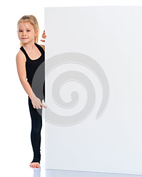 Little girl points a finger at a white banner.