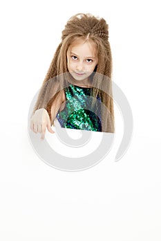 Little girl points a finger at a white banner.